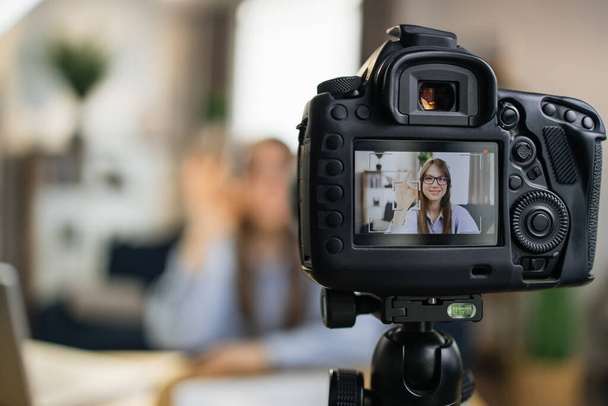 Female influencer using camera for leading live streaming - Foto, afbeelding