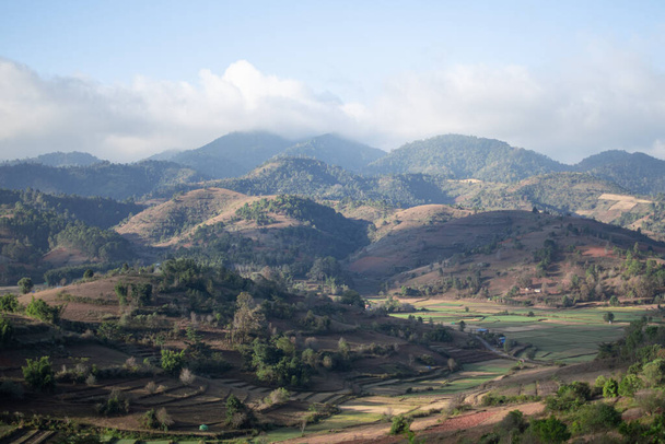 Beautiful farm lands and fields by rolling hills while on hike from Kalaw to Inle Lake, Shan state, Myanmar - Photo, image