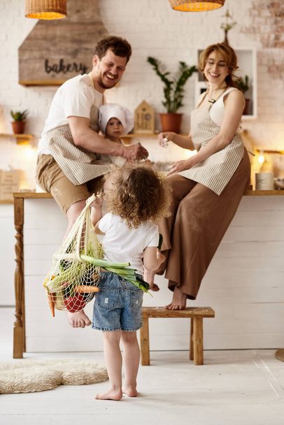 happy family with their children cooking in the kitchen - Photo, image