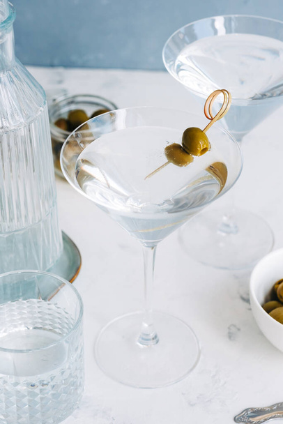 Martini cocktail in a glass on white background with olives. top view - Fotó, kép
