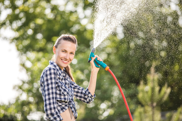 Summer garden woman watering lawn - Foto, Imagen