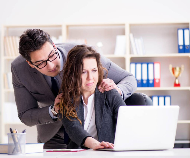 Sexual harassment concept with man and woman in office - Fotoğraf, Görsel
