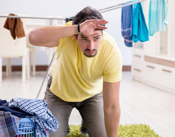 Handsome man husband doing laundering at home - Photo, Image