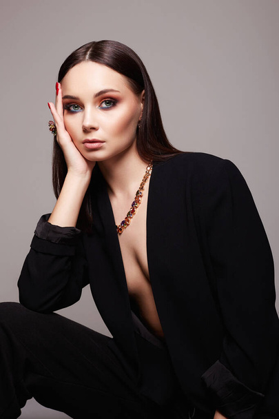 fashion portrait of Beautiful sexy woman in jewelry. gold jewelry on brunette sexual girl - Fotó, kép