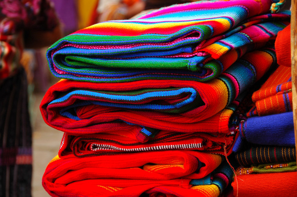 Brightly colored Mayan textiles in the market - Photo, Image