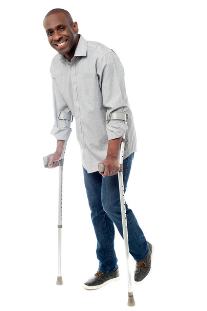 Man with crutches trying to walk - Photo, image