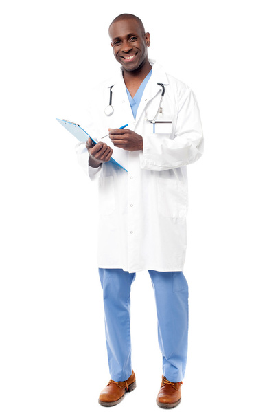 Doctor standing with a clipboard - Φωτογραφία, εικόνα