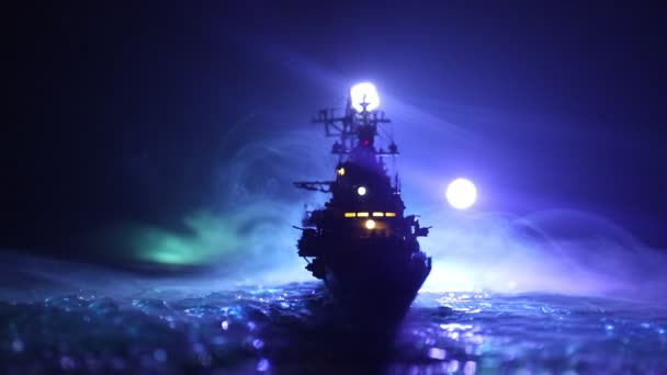 War concept. Night battle scene at sea. Dramatic toned clouds effect. Silhouette of the battle ship in night. Miniature creative table decoration. Selective focus - Footage, Video