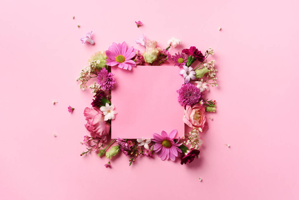 Frame of pink flowers over punchy pastel background. Valentines day, Woman day concept. Spring or summer banner with copy space - Foto, afbeelding