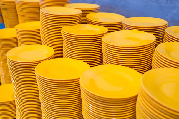 Stack of yellow plate in a grilled buffet restaurant in Thailand - Foto, Imagem