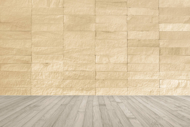 Yellow beige rock tile wall with wooden floor in light sepia brown color for interior backgroun - Photo, Image