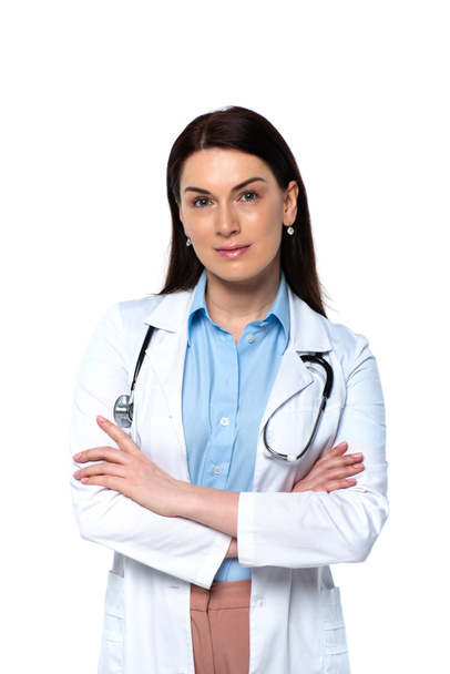 Brunette doctor with stethoscope looking at camera isolated on white  - Zdjęcie, obraz