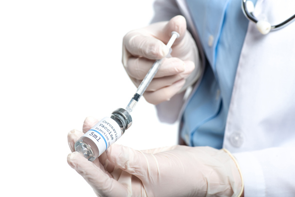 Cropped view of doctor in latex gloves holding jar with vaccine and syringe isolated on white  - Photo, Image