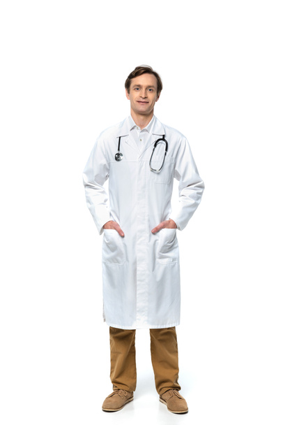 Doctor in white coat looking at camera on white background  - Fotoğraf, Görsel