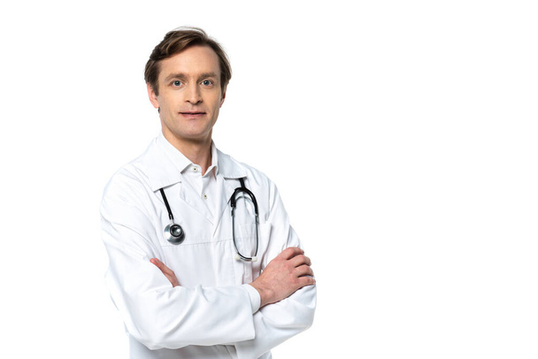 Doctor with crossed arms looking at camera isolated on white  - Фото, изображение