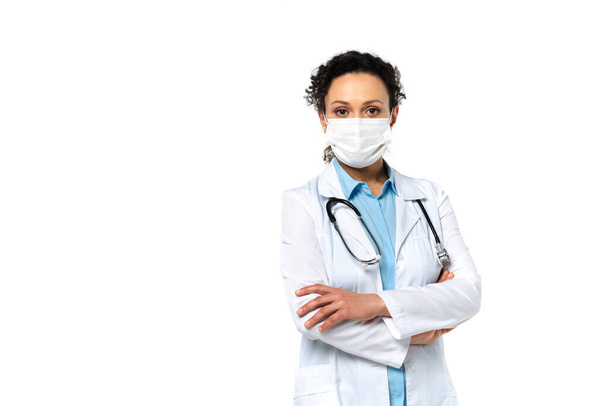 African american doctor in protective mask standing isolated on white  - Фото, зображення