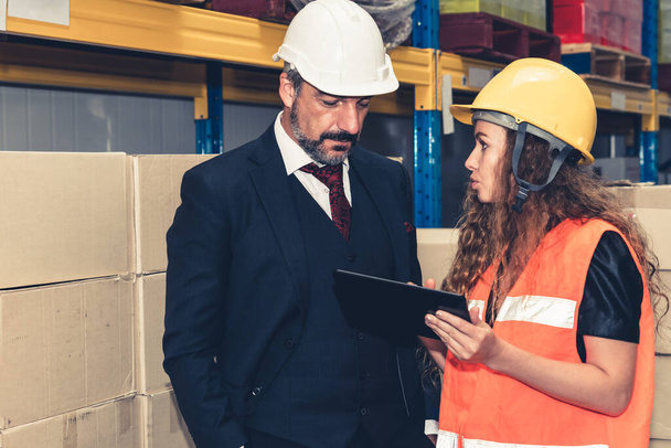Warehouse senior manager discuss with worker in the storehouse - Φωτογραφία, εικόνα