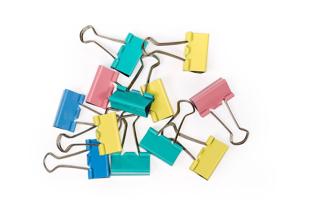 Multi colored metal binder clips on a white background, top view close-up - Photo, Image