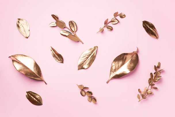 Golden leaves on pink background. Top view. Copy space. Summer and autumn concept. Creative design elements for invitation, wedding cards, valentines day, greeting cards. - Φωτογραφία, εικόνα