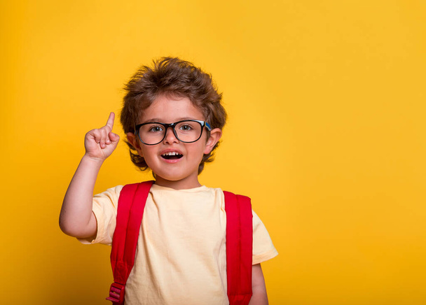Child boy with finger up. Innovation and idea. Smart kid in eyeglasses press the flying imagine symbol. Back to school, kindergarte - Valokuva, kuva