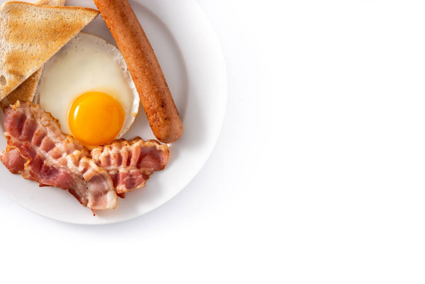 Traditional American breakfast with fried egg,toast,bacon and sausage isolated on white background - Photo, Image