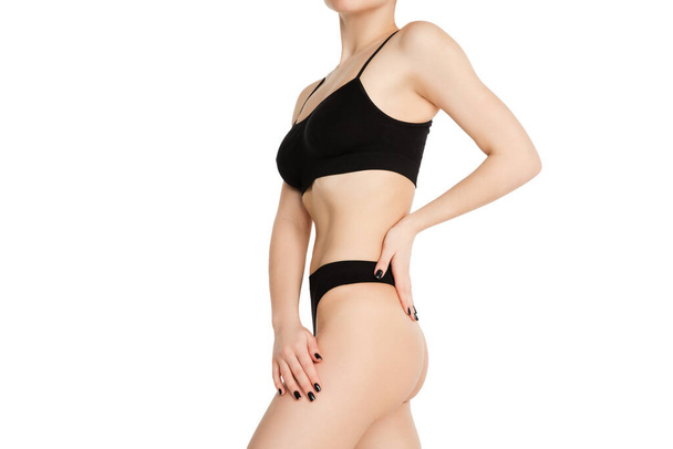 Beautiful female body in black underwear over white background. - Fotografie, Obrázek