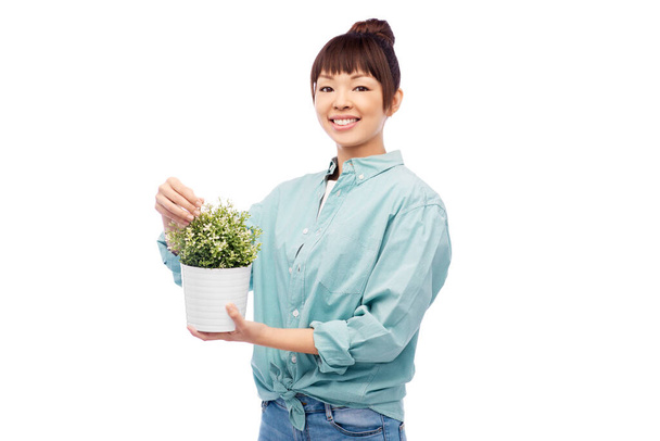 happy smiling asian woman holding flower in pot - Zdjęcie, obraz