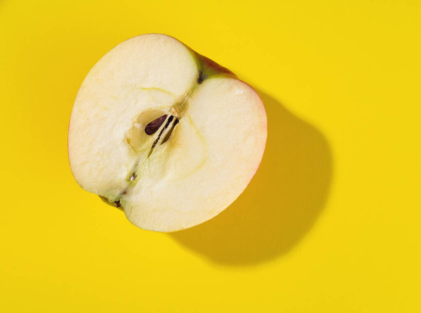 Half apple on a yellow background - Photo, Image