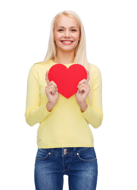 smiling woman with red heart - Φωτογραφία, εικόνα
