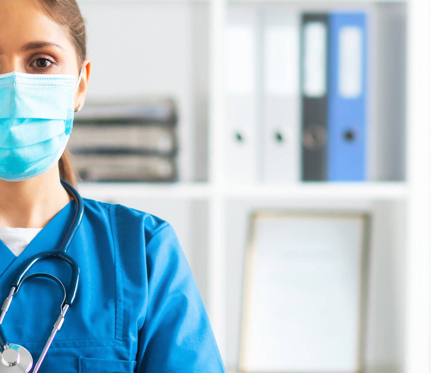 Professional medical doctor working in hospital office, Portrait of young and attractive female physician in protective mask. - Foto, Imagem