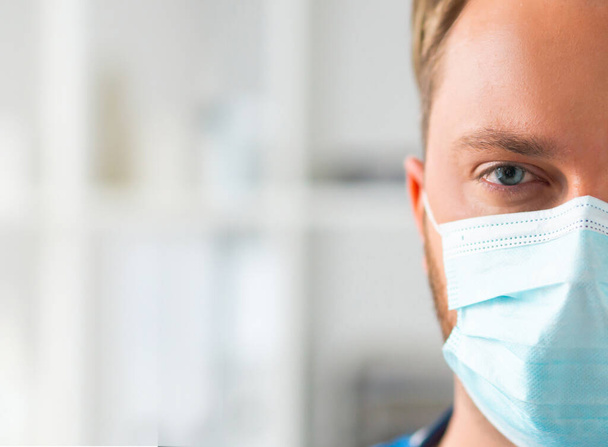 Professional medical doctor in hospital office, Portrait of young and confident physician in protective mask. - Fotografie, Obrázek