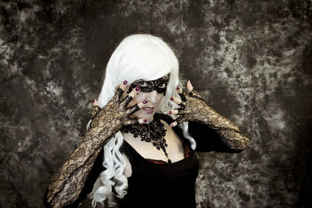 Woman disguised in gothic style for halloween party with mask - Foto, Imagem