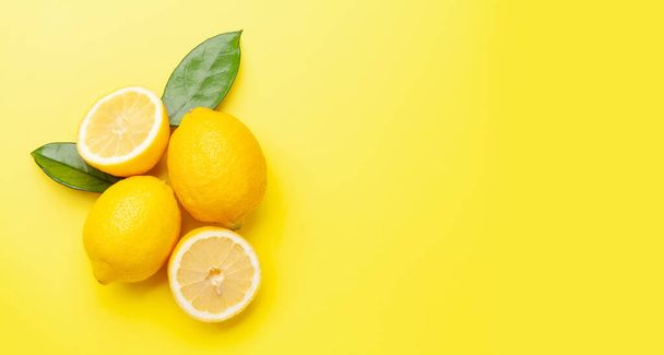 Fresh ripe lemons on yellow background. Top view flat lay with copy space - Photo, Image