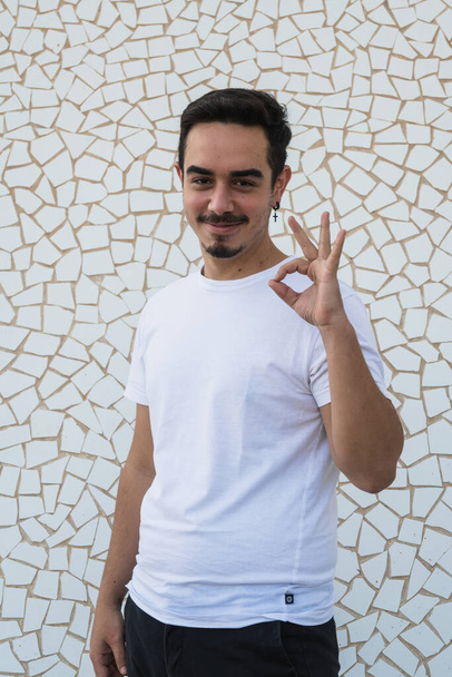 Menino com bigode e camisa branca expressando emoções no fundo branco - Foto, Imagem