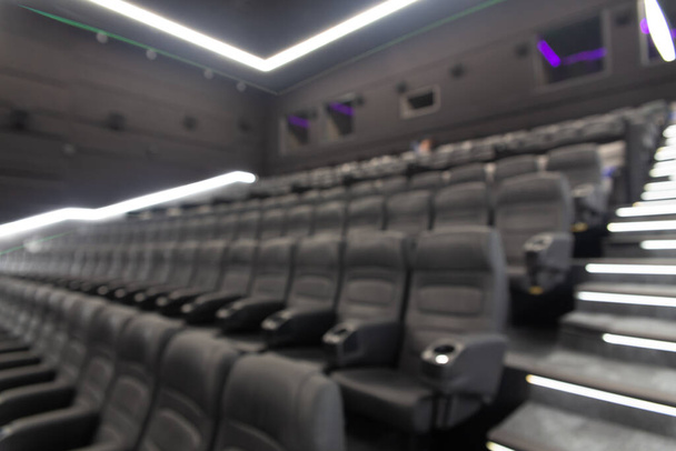 Defocused image of empty black leather seats at movie theater - great entertainment fun background image - Фото, изображение
