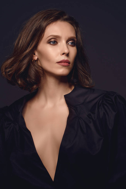 Portrait of beautiful brunette woman in black dress. Fashion pho - Fotó, kép
