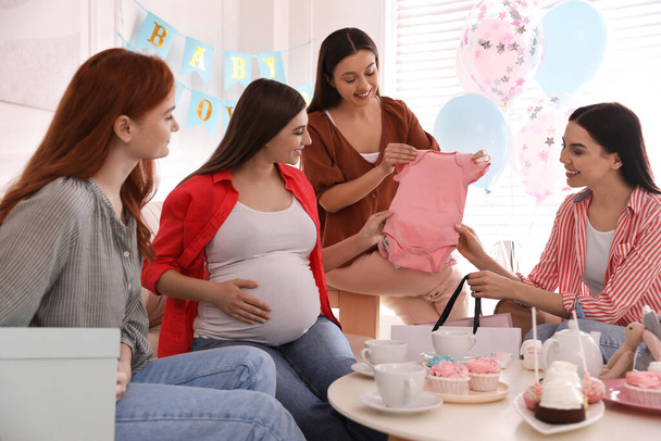Happy pregnant woman spending time with friends at baby shower party - Foto, afbeelding