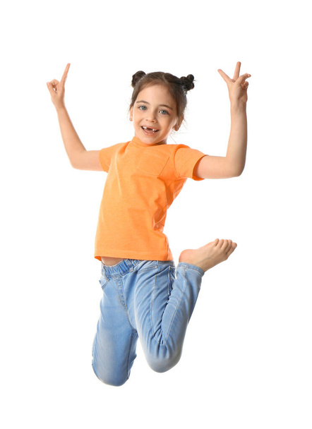 Cute little girl jumping on white background - Фото, изображение