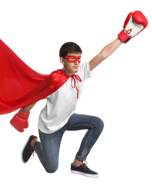 Teenage boy in superhero costume on white background - Фото, зображення