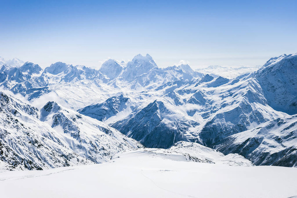 Snowy winter Greater Caucasus mountains at sunny day. View from ski slope Elbrus, Kabardino-Balkaria, Russia - Φωτογραφία, εικόνα