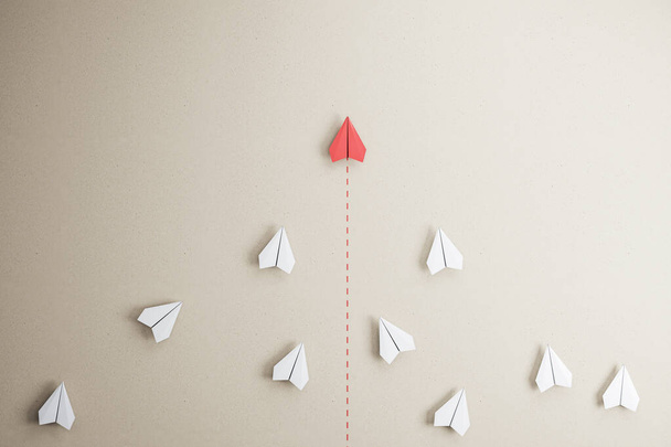 Success goal and creative idea concept with red paper plane compete with white paper planes on abstract beige wallpaper. 3D rendering - Photo, Image