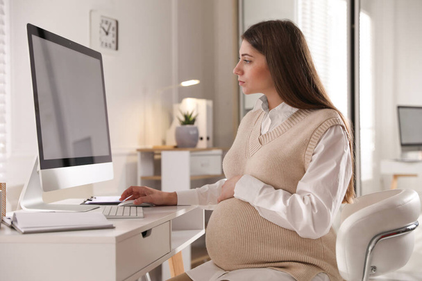 Pregnant woman working at home. Maternity leave - Fotó, kép