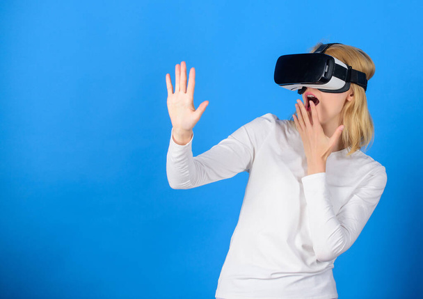 Beautiful woman wearing virtual reality goggles in studio. Confident young woman adjusting her virtual reality headset and smiling. Excited smiling businesswoman wearing virtual reality glasses. - Foto, Imagem