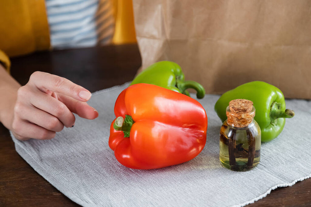 cropped view of woman reaching bell peppers  - Photo, Image