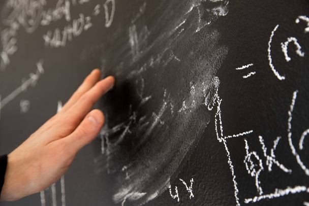 Mathematical formulas on dark black chalk board - 写真・画像
