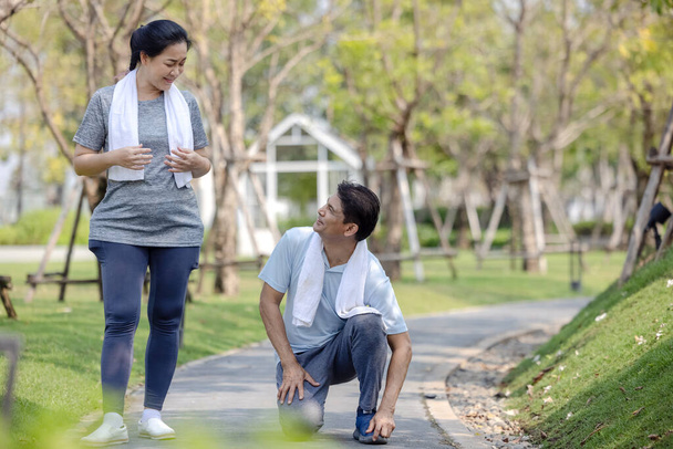 Smiling senior active couple exercise jogging together in the par - Photo, Image