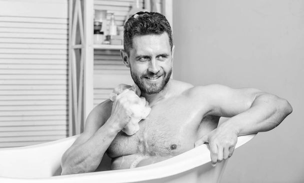 Sex and relaxation concept. personal care. Sexy man in bathroom. hygiene and health. Guy in bathroom with toiletries Macho naked in bathtub. man wash muscular body with sponge. man with nude torso. - Valokuva, kuva