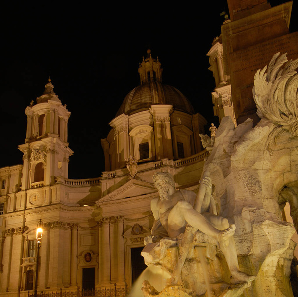 Night in Rome. View of the beautiful Piazza Navona square baroque monuments illuminated, erected in the 17th century - Photo, Image
