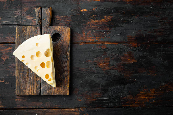 Maasdam cheese set, on old dark  wooden table, top view flat lay, with copy space for text - 写真・画像