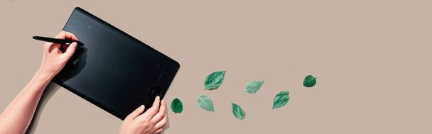 Graphic pen tablet with green leaves - Photo, Image